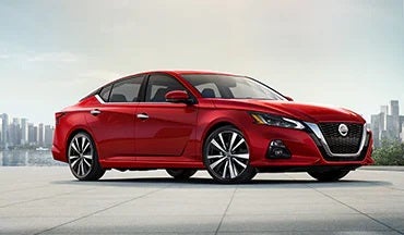 2023 Nissan Altima in red with city in background illustrating last year's 2022 model in Nissan of Cookeville in Cookeville TN