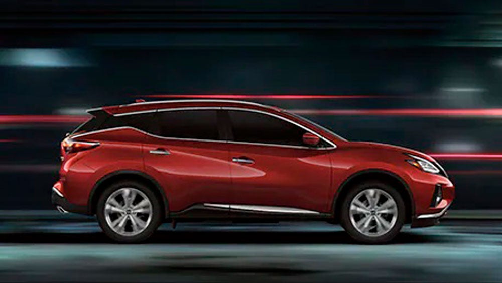 2023 Nissan Murano shown in profile driving down a street at night illustrating performance. | Nissan of Cookeville in Cookeville TN